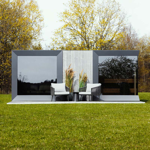 Front-facing view of Geneva St. Moritz outdoor sauna with shower room, framed by trees in bloom and minimalist decor.