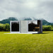 Geneva St. Moritz outdoor sauna with shower room set against dramatic misty mountain backdrop, showcasing sleek mirrored glass panels and contemporary modular design in nature.