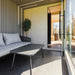 Modern Geneva St. Moritz sauna lounge with glass door open, showing interior heater and natural wood finishes.