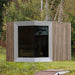 Modern Zermatt outdoor sauna cabin with changing room, featuring sleek timber cladding and panoramic front glass, set in a tranquil forest clearing.