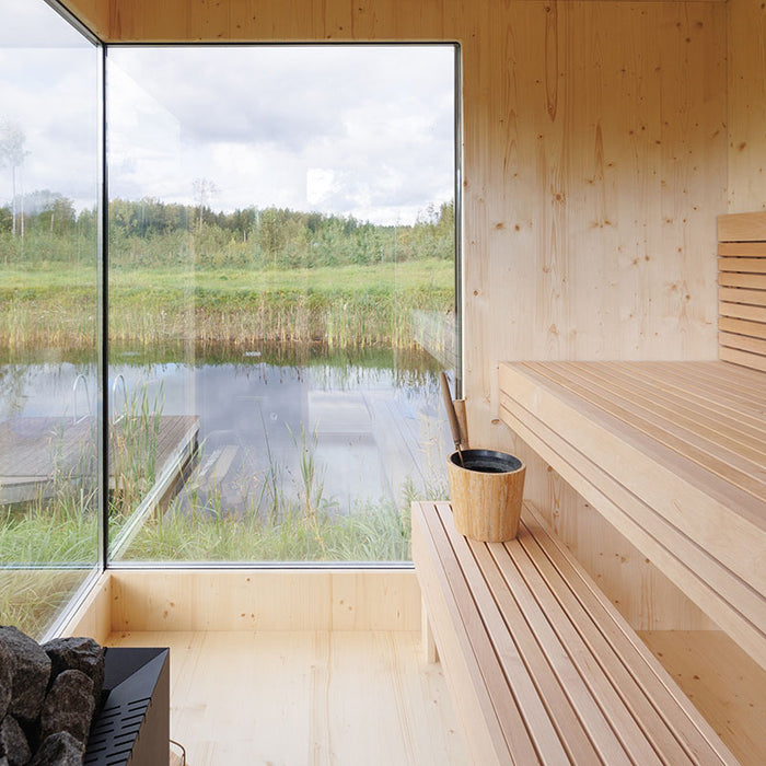 Clean interior corner of the Zermatt sauna with tiered seating, timber walls, and corner glass windows providing stunning outdoor views.
