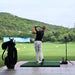Golfer practising at a driving range with the Golfjoy GDS Plus Launch Monitor, capturing detailed metrics for each swing.