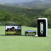 The Golfjoy GDS Plus Launch Monitor set up on a golf course, with a laptop and smartphone displaying the real-time shot data and analysis.
