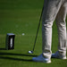 A golfer using the Golfjoy GDS Plus Launch Monitor on a golf course, demonstrating its practical application and ease of use during practice.