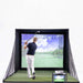 A person using the Golfjoy Personal Golf Simulator in a basic setup, with a large screen and hitting mat.