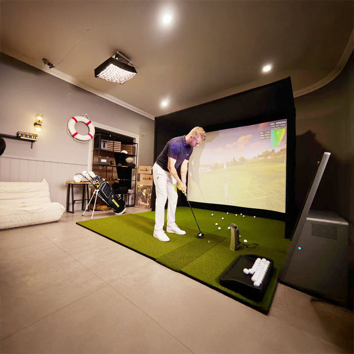 Golfer using the Golfjoy Personal Golf Simulator to practise putting in a professional-level indoor training environment.