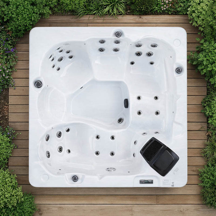 Overhead view of the H2O Azure 5-Person Hot Tub on wooden decking showing full white acrylic interior, complete jet layout, seating configuration, and built-in speaker