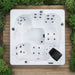 Overhead view of the H2O Azure 5-Person Hot Tub on wooden decking showing full white acrylic interior, complete jet layout, seating configuration, and built-in speaker