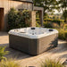 H2O Retreat Pro 5-Person Hot Tub with white shell and warm brown cabinet installed on a timber deck in a rural UK countryside setting