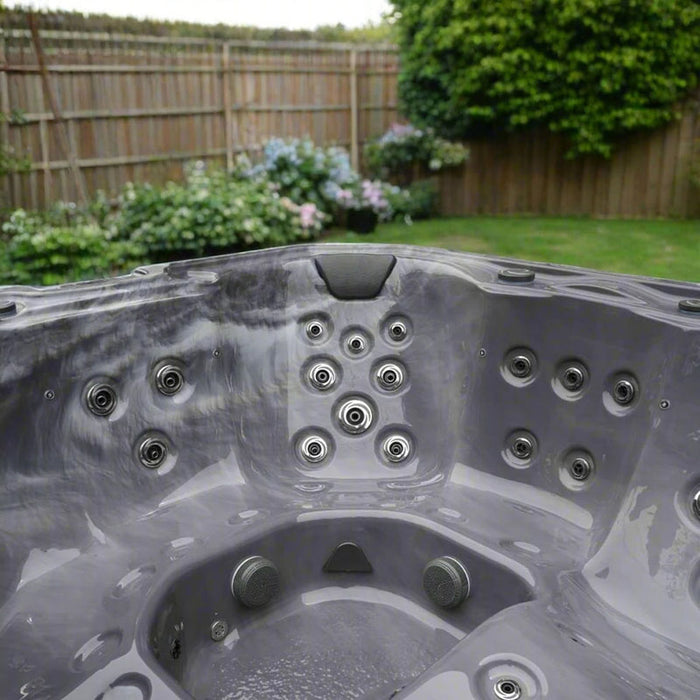 H2O Vortex 6-Person Hot Tub grey interior close-up highlighting concentrated stainless steel jet cluster and moulded headrest position