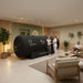 Therapist assisting a woman after a session inside the Henshaw 1662 Hyperbaric Oxygen Chamber, with another patient relaxing in a calming clinic.