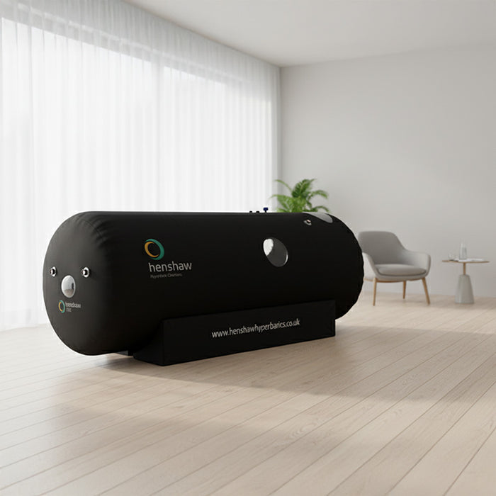 Henshaw 1662 Hyperbaric Oxygen Chamber in a bright therapy space with natural light, minimalist furniture, and lush indoor plants.