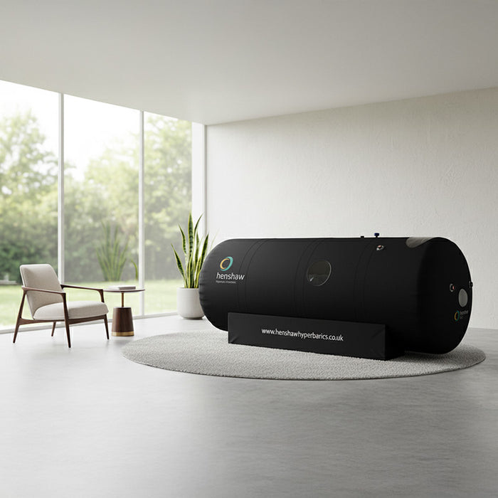 Henshaw 1662 Hyperbaric Oxygen Chamber placed in a bright minimalist room with garden views, ideal for wellness and home therapy.