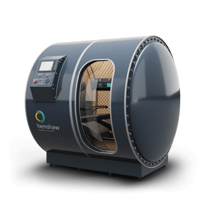 Studio-rendered image of the Henshaw Duoplace Hyperbaric Chamber with transparent entry, dual seating capacity, and curved aluminium body.