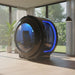 Side view of the Henshaw Monozen Hyperbaric Chamber in a luxury home setting, showing illuminated blue accents and ergonomic interior chair for advanced oxygen therapy.