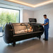 Female patient lying inside the Henshaw Pro Hyperbaric Chamber receiving monitored oxygen therapy, assisted by a medical professional in a private clinic setting.