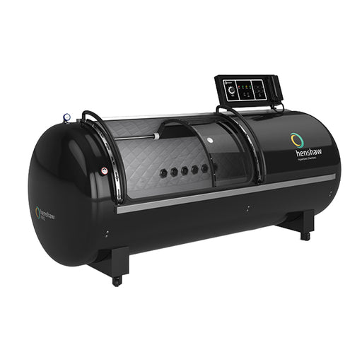 Side view of the Henshaw Pro Hyperbaric Oxygen Chamber showing its sleek black cylindrical design and advanced digital control panel for oxygen therapy and wellness treatments.