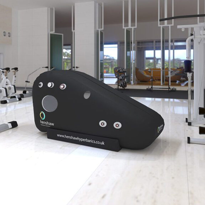 Henshaw Recline Hyperbaric Oxygen Chamber displayed in a modern gym setting for professional recovery and sports therapy.