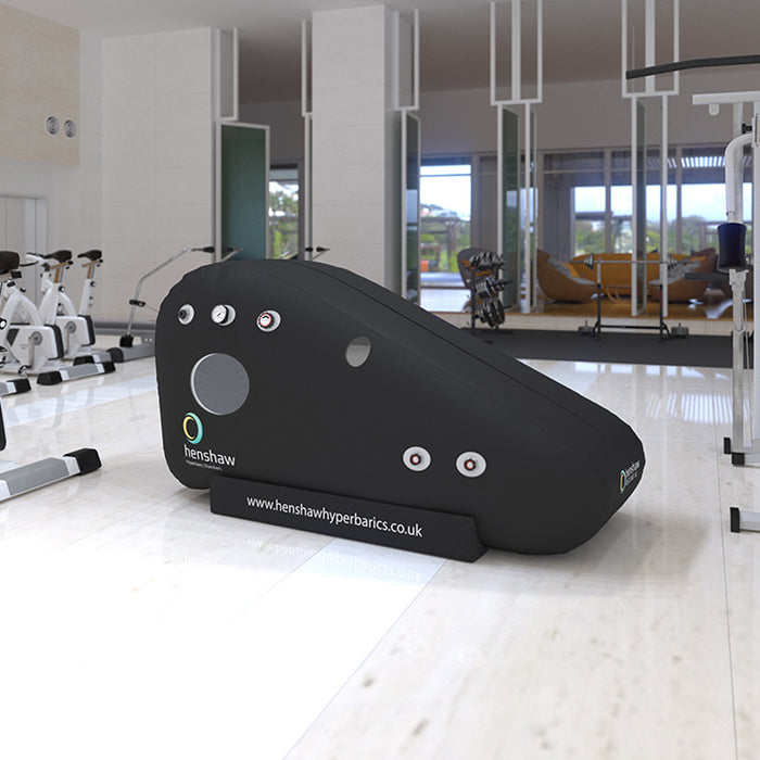 Henshaw Recline XL Hyperbaric Oxygen Chamber positioned in a modern fitness facility for enhanced recovery and wellness.
