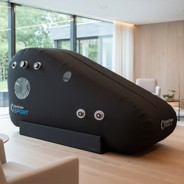 Henshaw Recline XL Sport Hyperbaric Oxygen Chamber in a stylish lounge area, designed for sports recovery and oxygen therapy.