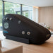 Henshaw Recline XL Sport Hyperbaric Oxygen Chamber in a stylish lounge area, designed for sports recovery and oxygen therapy.