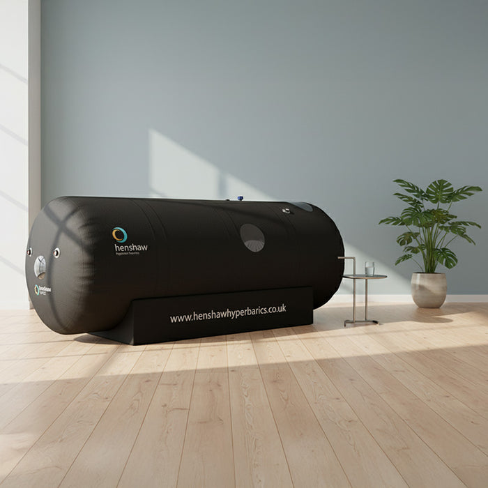 Henshaw Space Hyperbaric Oxygen Chamber placed in a bright and airy room with sunlight casting soft shadows, perfect for private in-home use.