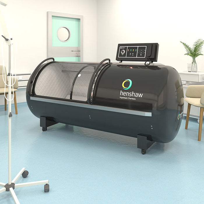 Henshaw XL Pro Hyperbaric Oxygen Chamber installed in a modern clinical setting, featuring control panel, cushioned interior, and durable build for advanced oxygen therapy applications.