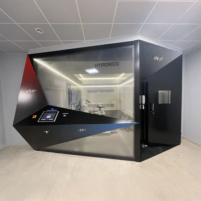 Hypoxico Full Climate Hypoxic Chamber interior with curved treadmill handrail in foreground and branded black entry door with observation window in background.
