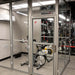 Hypoxico Hypoxic Altitude Chamber boxing room with four hanging heavy bags, alpine mountain murals on all walls, and padded dark floor matting.