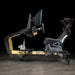 Side profile of the ImSim TERRA racing simulator in black and gold with ergonomic racing seat, steering wheel mount and pedal platform.