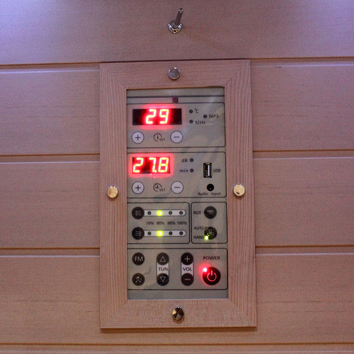 Control panel of the Insignia KY001 Infrared Indoor Sauna, with illuminated digital display and audio controls for temperature and sound settings.