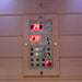 Control panel of the Insignia KY001 Infrared Indoor Sauna, with illuminated digital display and audio controls for temperature and sound settings.