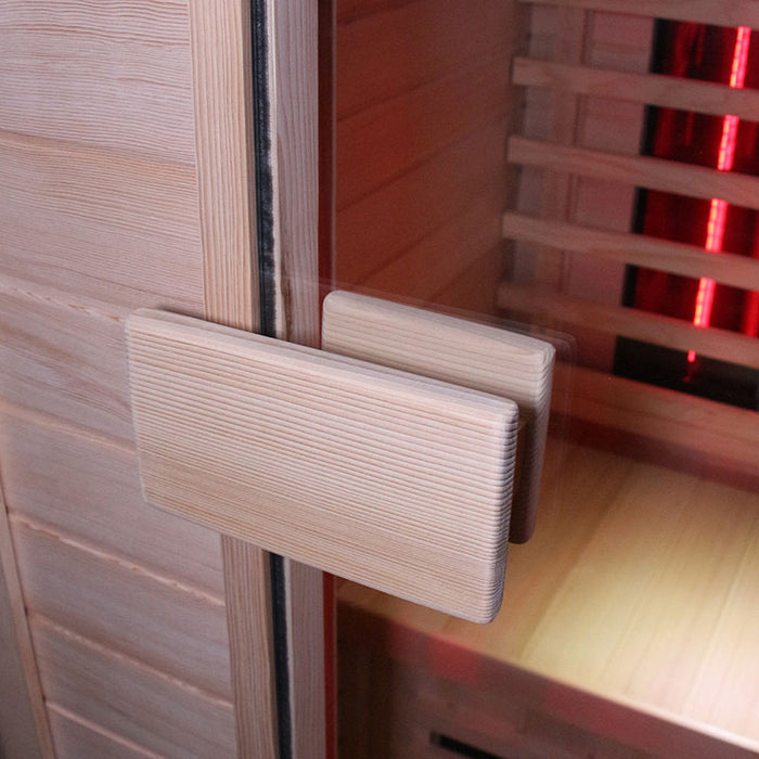  Close-up of the door handle of the Insignia KY001 Infrared Indoor Sauna, showcasing the durable wooden design and smooth finish.