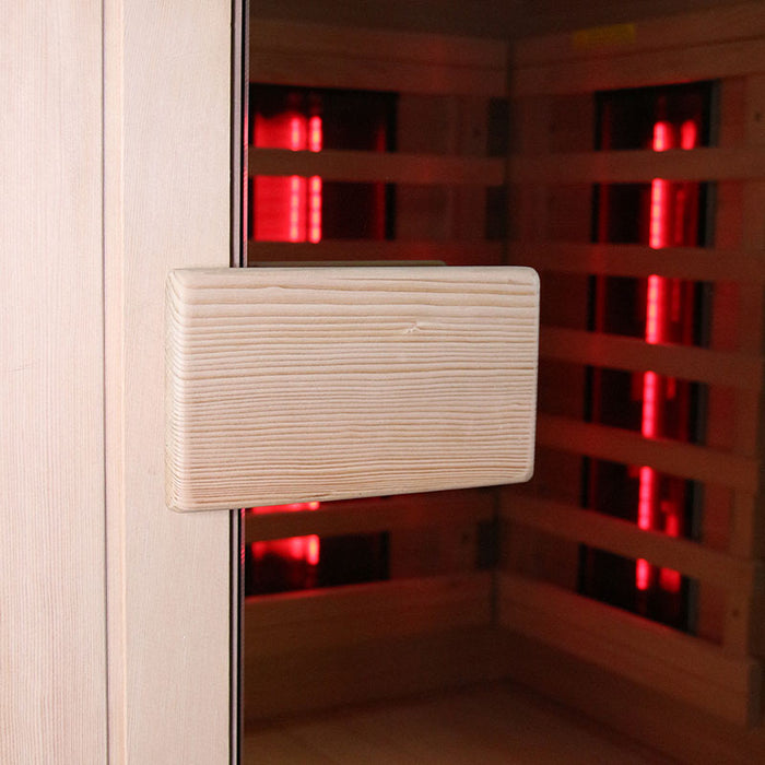 Close-up of the door handle on the Insignia KY002 Infrared Indoor Sauna, featuring a robust wood finish and precise craftsmanship.