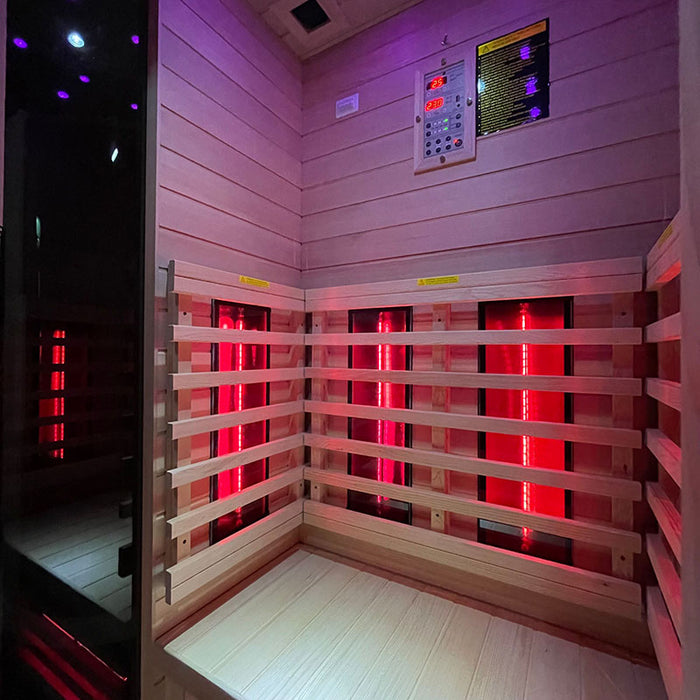 Interior of the Insignia KY002 Infrared Indoor Sauna 1000 x 900, featuring powerful infrared heaters and comfortable wooden seating, bathed in red light.