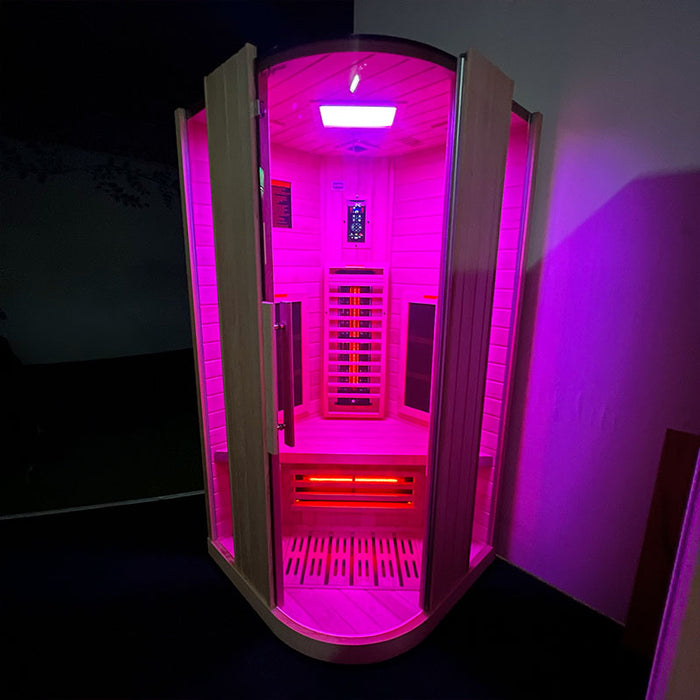 Exterior view of the Insignia KY003 Infrared Indoor Sauna 1000 x 1000mm with pink LED chromotherapy lighting, creating a vibrant and soothing atmosphere.