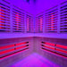 Low-angle shot of the Insignia KY006 Infrared Indoor Sauna's interior, showcasing the even distribution of infrared heaters and ambient blue lighting.