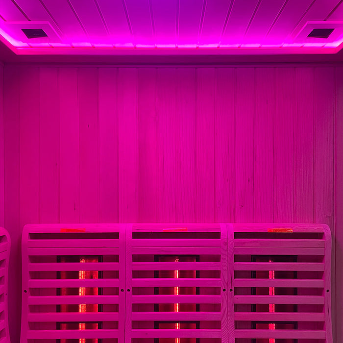 Interior of the Insignia KY006 Infrared Indoor Sauna illuminated in soothing pink LED Chromotherapy lighting, highlighting the spacious and comfortable seating.