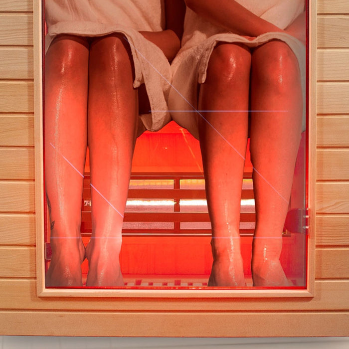 Close-up view of two people enjoying the heat therapy inside the Insignia KY008 Infrared Indoor Sauna 1300 x 1000, highlighting comfortable dual seating and red lighting.