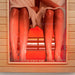 Close-up view of two people enjoying the heat therapy inside the Insignia KY008 Infrared Indoor Sauna 1300 x 1000, highlighting comfortable dual seating and red lighting.