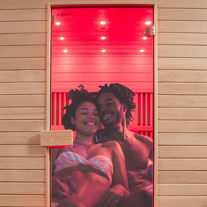 Smiling couple enjoying the Insignia KY009 Infrared Indoor Sauna 1500 x 1000, immersed in warm red light for a luxurious at-home spa experience.