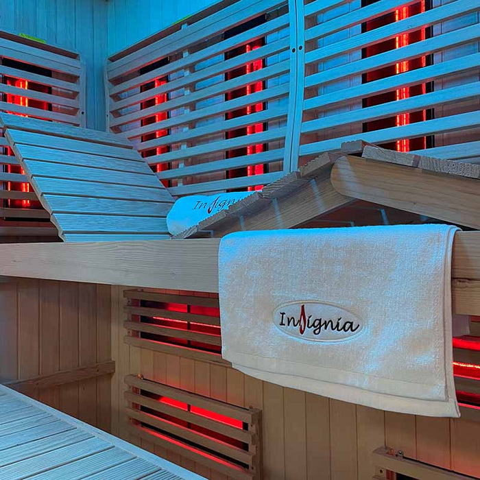 Relaxing wooden bench inside the Insignia KY2216 Sauna, illuminated by infrared heaters strategically placed for full-body warmth and comfort.