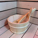 A close-up of the handcrafted wooden bucket and ladle in the Insignia Outdoor Hybrid Infrared Sauna 1700 x 1500mm, perfectly complementing the traditional Finnish sauna experience with quality natural wood materials.