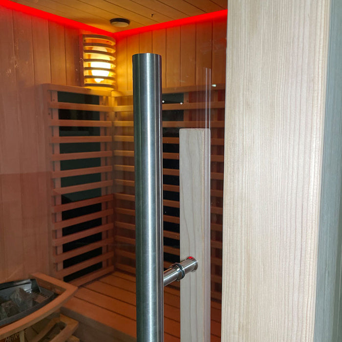 A close-up of the sleek, stainless steel door handle on the Insignia Outdoor Hybrid Infrared Sauna 1700 x 1500mm, highlighting the high-quality tempered glass door and handcrafted Canadian Hemlock wood frame for a modern, durable finish.