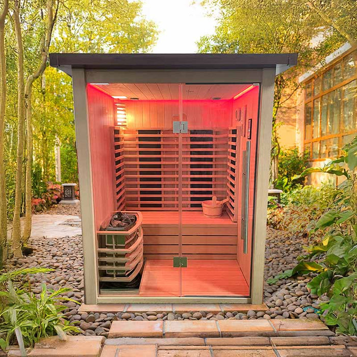 The Insignia Outdoor Hybrid Infrared Sauna 1700 x 1500mm placed in a serene garden setting, emphasising its modern design with infrared heating and traditional Finnish stove, surrounded by lush greenery for a tranquil wellness retreat.