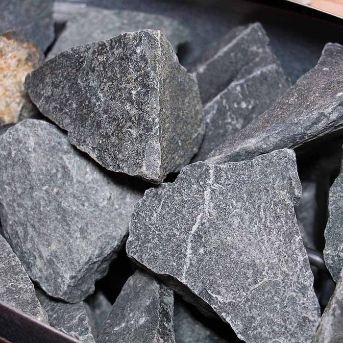 A detailed shot of the peridotite rocks used in the Harvia stove inside the Insignia Outdoor Hybrid Infrared Sauna 1700 x 1500mm, designed to provide authentic Finnish steam heat.