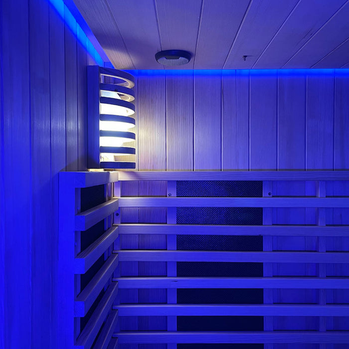 The wooden wall lamp in the Insignia Outdoor Hybrid Infrared Sauna 1700 x 1500mm bathed in serene blue LED Chromotherapy lighting, creating a peaceful and relaxing environment.