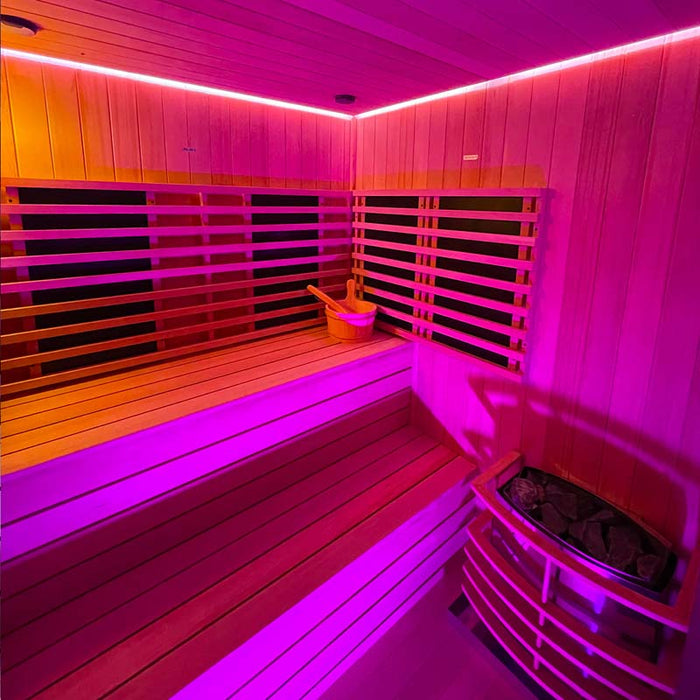 Wide-angle view of the Insignia Outdoor Hybrid Infrared Sauna 2000 x 2000mm with vibrant pink and yellow LED Chromotherapy lighting for a rejuvenating experience.