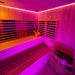 Wide-angle view of the Insignia Outdoor Hybrid Infrared Sauna 2000 x 2000mm with vibrant pink and yellow LED Chromotherapy lighting for a rejuvenating experience.