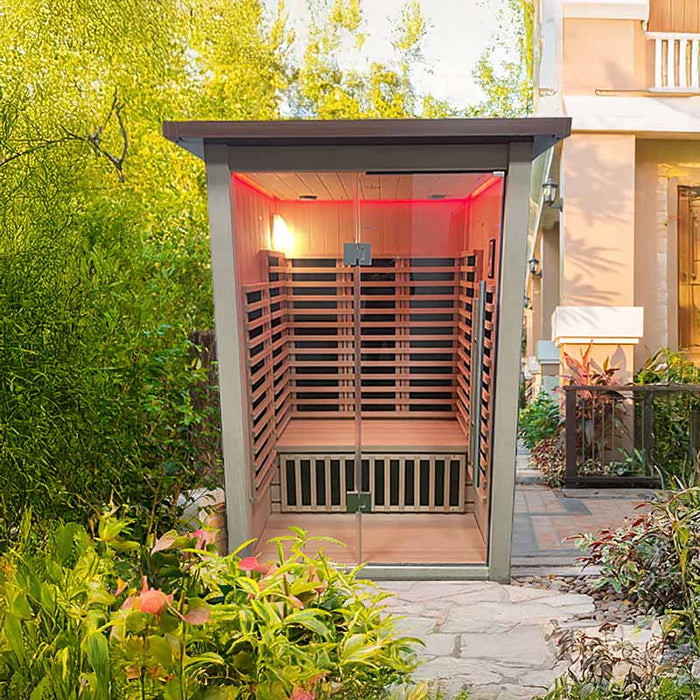 Front view of the Insignia Outdoor Infrared Sauna in a stylish outdoor setting, featuring a glass front panel and high-quality wooden finish.